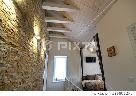 Interior of a contemporary home with spacious hallway, room doors and staircase railing in modern style. 129806276