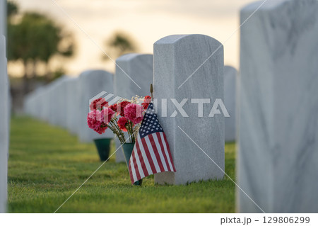 American army Sarasota National Cemetery with rows of white tombstones with USA flags and flowers. Memorial Day concept 129806299
