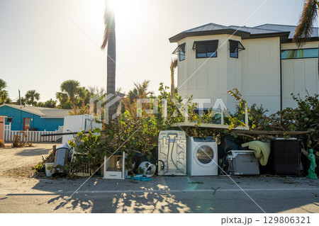 Heaps of debris rubbish on street side near severely damaged by hurricane Milton houses in Florida residential area on Manasota Key in Englewood. Consequences of natural disaster Heaps of debris rubbish on street side near severely damaged by hurricane Milton houses in Florida residential area on Manasota Key in Englewood. Consequences of natural disaster 129806321