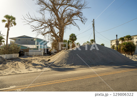 Cleanup efforts after hurricane in Florida. Piles of broken furniture, household debris and construction waste line streets of Manasota Key, showing severe impact on local homes and infrastructure Cleanup efforts after hurricane in Florida. Piles of broken furniture, household debris and construction waste line streets of Manasota Key, showing severe impact on local homes and infrastructure 129806322