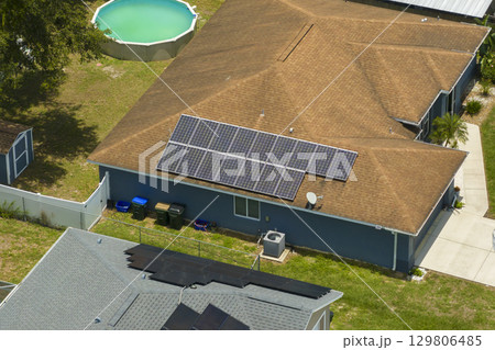 Photovoltaic solar panels on Florida home roof for producing clean ecological electric energy. Renewable electricity with zero emission concept 129806485