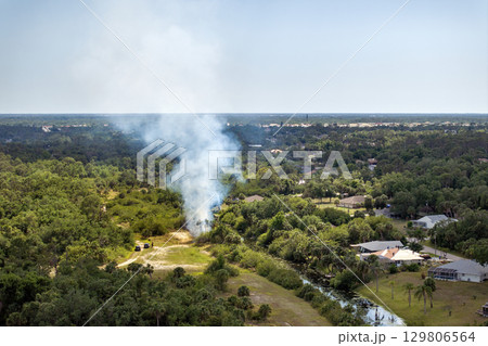 Vegetation fire in Florida forest adjacent to homes, as residents evacuate and smoke polluting air over neighborhood Vegetation fire in Florida forest adjacent to homes, as residents evacuate and smoke polluting air over neighborhood 129806564
