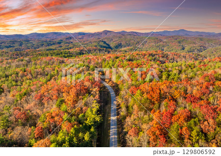 Peaceful mountain road in North Carolina during peak fall season at sunset. Appalachian landscape filled with vivid autumn colors 129806592