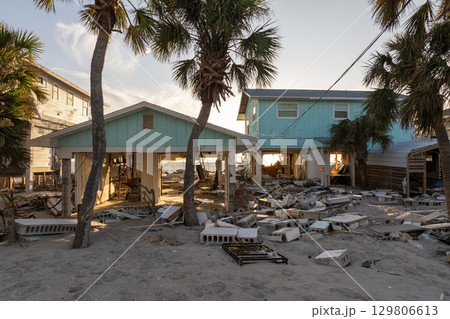 Ruined buildings in need of demolition or repair. Storm surge water and wind damaged houses roof and collapsed walls after hurricane in Florida 129806613