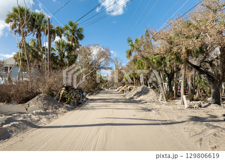 Hurricane aftermath cleanup. Piles of debris on street side in Florida. Garbage from severely damaged homes after storm surge. Consequences of natural disaster Hurricane aftermath cleanup. Piles of debris on street side in Florida. Garbage from severely damaged homes after storm surge. Consequences of natural disaster 129806619