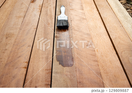 Paint brush and wood material in construction work. Paint brush and wood material in construction work. 129809887