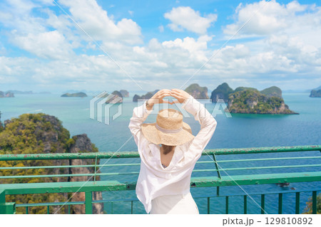 Woman tourist traveling in Krabi, Thailand. happy traveller enjoy and sightseeing view at koh Hong island viewpoint. summer trip, destination, Southeast Asia Travel, vacation and holiday concept 129810892