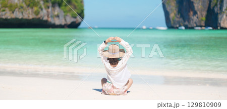 Woman tourist traveling and sightseeing in Krabi, Thailand, happy traveller enjoy at Maya Bay beach on Phi Phi island, Popular paradise island, destination, Southeast Asia Travel, vacation and holiday Woman tourist traveling and sightseeing in Krabi, Thailand, happy traveller enjoy at Maya Bay beach on Phi Phi island, Popular paradise island, destination, Southeast Asia Travel, vacation and holiday 129810909