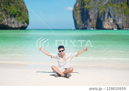 man tourist traveling and sightseeing in Krabi, Thailand, happy traveller enjoy at Maya Bay beach on Phi Phi island, Popular paradise island, destination, Southeast Asia Travel, vacation and holiday man tourist traveling and sightseeing in Krabi, Thailand, happy traveller enjoy at Maya Bay beach on Phi Phi island, Popular paradise island, destination, Southeast Asia Travel, vacation and holiday 129810939