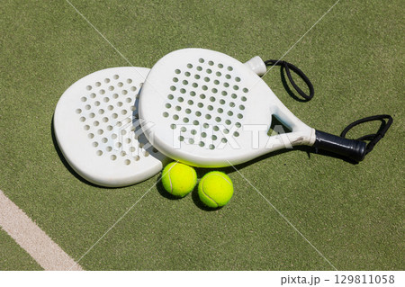 Rackets and balls on paddle tennis court Rackets and balls on paddle tennis court 129811058