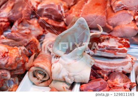 Pork laid out in showcase of butcher shop 129811165