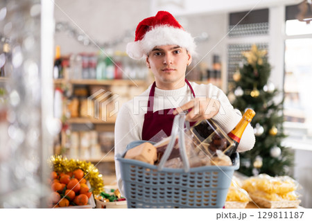 European guy seller stands in trading hall grocery, New Year Eve 129811187