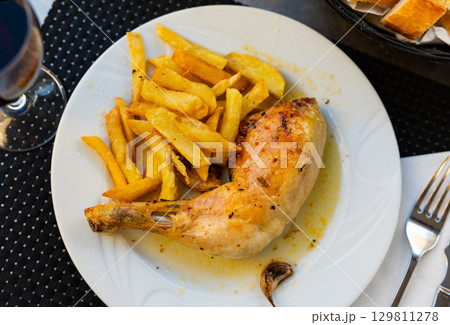 Beautifully served dish of grilled chicken thigh with fried potatoes 129811278
