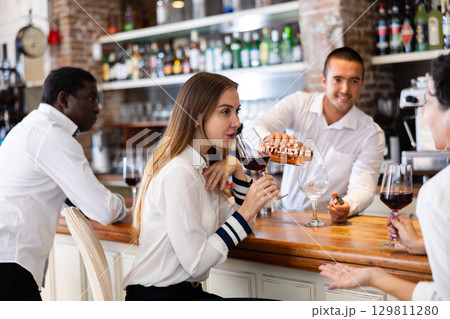 Two women sitting at the bar Two women sitting at the bar 129811280