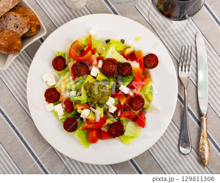 Feta and chorizo salad with avocado and pesto sauce Feta and chorizo salad with avocado and pesto sauce 129811306