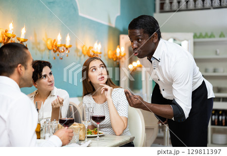 Three guests at the restaurant 129811397