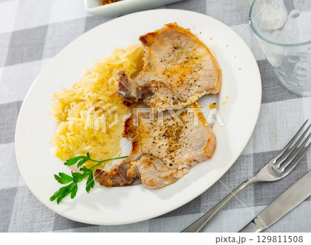 Fried pork served with marinated cabbage 129811508