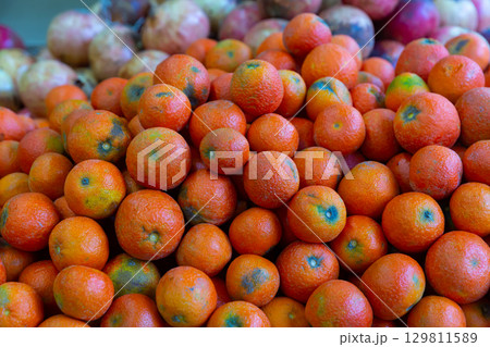 Showcase with damaged organic tangerines in greengrocery Showcase with damaged organic tangerines in greengrocery 129811589