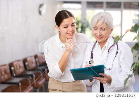 Woman consults with a doctor about the diagnosis and treatment of disease Woman consults with a doctor about the diagnosis and treatment of disease 129811617