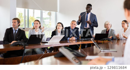 Mature african male speaker holding corporate meeting Mature african male speaker holding corporate meeting 129811684