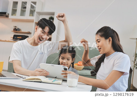 Family spends their free time together Family spends their free time together 129817619