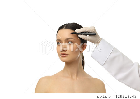 A beauty expert draws brow outlines on a client, isolated on white, PNG A beauty expert draws brow outlines on a client, isolated on white, PNG 129818345
