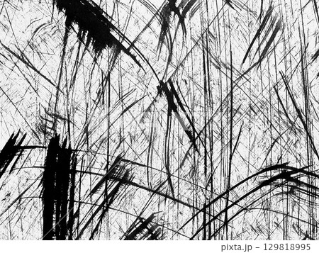 Abstract black and white texture with dynamic lines created by scratches on a surface 129818995