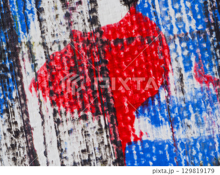 Bright abstract artwork featuring bold red and blue colors on textured wooden surface Bright abstract artwork featuring bold red and blue colors on textured wooden surface 129819179