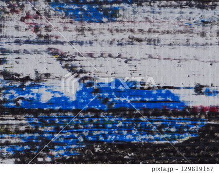 Textured abstract artwork featuring bold colors and layered patterns in a modern setting 129819187