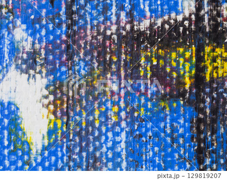 Colorful abstract artwork displayed on a textured surface in an artistic studio during daylight Colorful abstract artwork displayed on a textured surface in an artistic studio during daylight 129819207