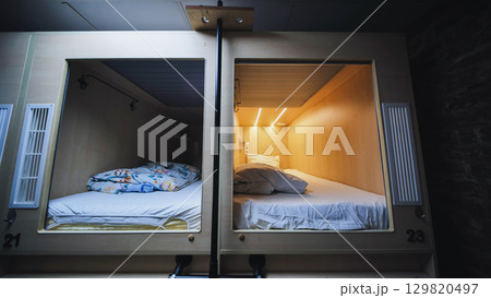 Capsule hotel beds inviting travelers for comfortable rest and privacy Capsule hotel beds inviting travelers for comfortable rest and privacy 129820497
