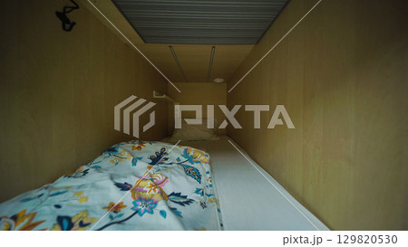 Cozy capsule hotel room inviting guests for comfortable rest Cozy capsule hotel room inviting guests for comfortable rest 129820530