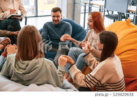 Talking, helping each other. Group of people are having therapy meeting together Talking, helping each other. Group of people are having therapy meeting together 129820638