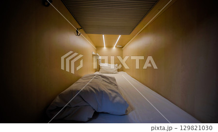Capsule hotel room inviting guests for comfortable overnight stay Capsule hotel room inviting guests for comfortable overnight stay 129821030
