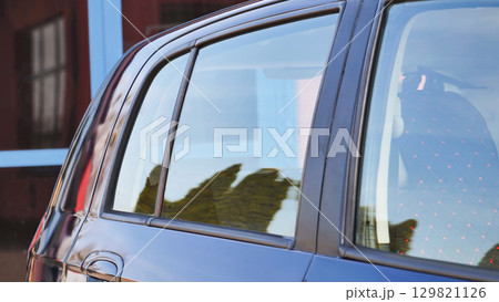 Clean car reflecting building and trees after car wash Clean car reflecting building and trees after car wash 129821126