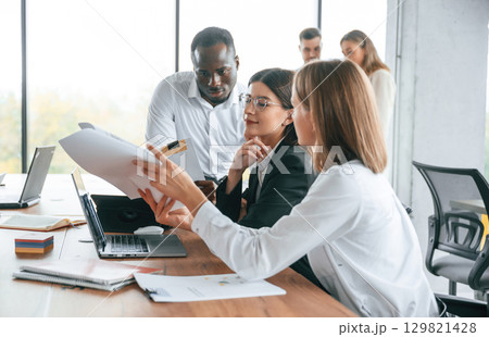 In the modern office. Group of workers are together indoors 129821428