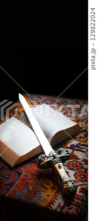 Old sword on the bible Old sword on the bible 129822024