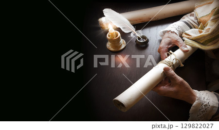 Man holding an old scroll 129822027