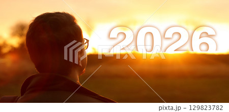 a man standing outside, his face turned toward the sunlight. concept of hope and wellness in the year 2026. hope concept man 2026 a man standing outside, his face turned toward the sunlight. concept of hope and wellness in the year 2026. hope concept man 2026 129823782
