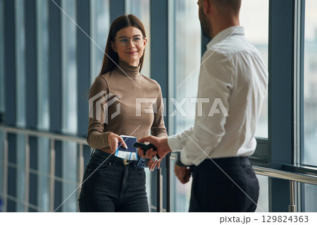 Woman is with airport worker, with tickets Woman is with airport worker, with tickets 129824363