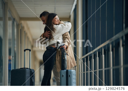 Farewell, embracing each other. Couple are in the airport hall together 129824576
