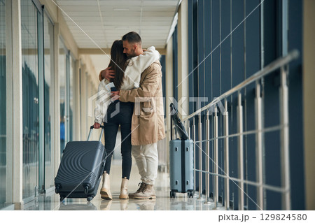 Embracing each other. Couple are in the airport hall together 129824580
