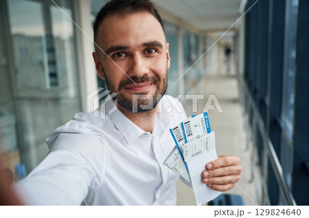 Making selfie, happy facial expression. Young handsome man in the airport Making selfie, happy facial expression. Young handsome man in the airport 129824640