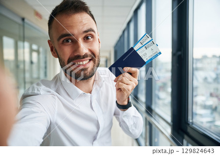 Making selfie, happy facial expression. Young handsome man in the airport Making selfie, happy facial expression. Young handsome man in the airport 129824643