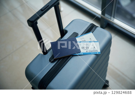 Luggage bag with tickets for flight on it, close up view Luggage bag with tickets for flight on it, close up view 129824688