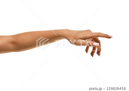 Female hand with white manicure in elegant reaching gesture isolated. Female hand with white manicure in elegant reaching gesture isolated. 129826458