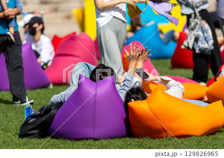 People relaxing on colorful bean bags in Seoul Plaza located in front of Seoul City Hall at Taepyeongno, Jung District, Seoul, South Korea 129826965