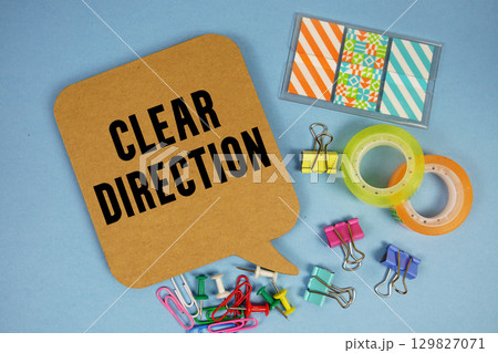 Clear Direction text with stationery on blue background 129827071