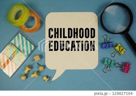 Childhood Education text with magnifying glass on blue background Childhood Education text with magnifying glass on blue background 129827104
