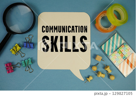 Communication Skills text with magnifying glass on blue background Communication Skills text with magnifying glass on blue background 129827105